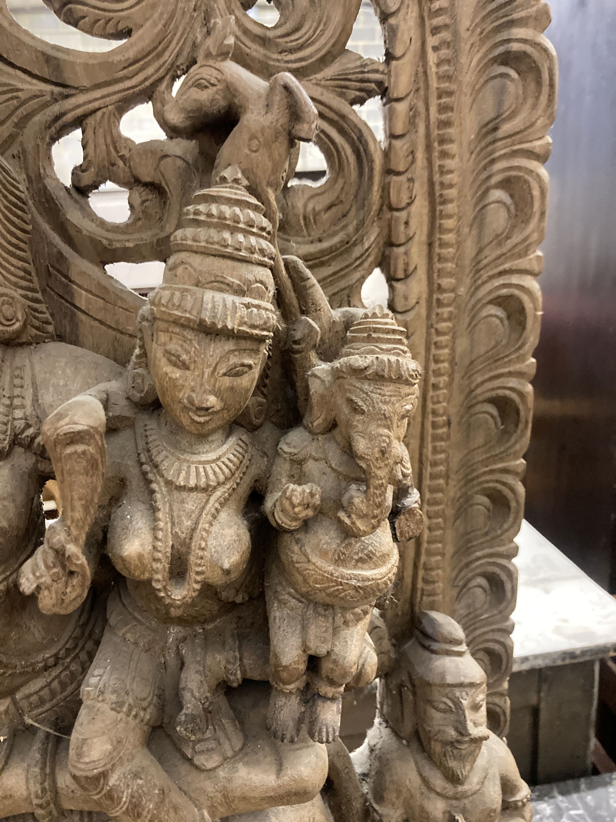 An Indian carved wood deity, width 50cm, depth 15cm, height 90cm